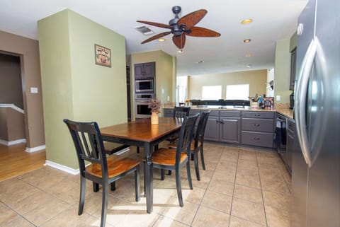 The open kitchen and dining area offers a warm, homey feel—perfect for gathering after a day on the lake.
