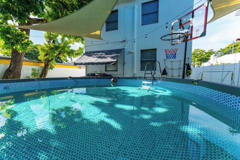 Cool off in the pool and shoot hoops under the shade—perfect for fun!