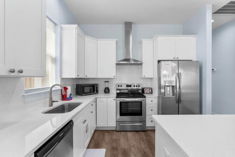 Modern kitchen with stainless steel appliances and ample counter space.