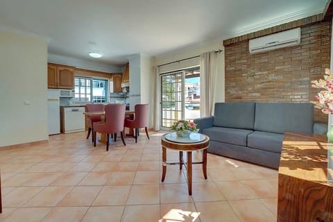 Living area, dining table and kitchen