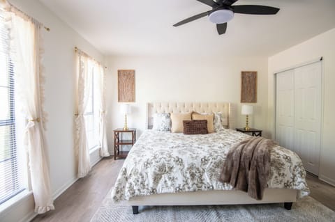 Peaceful primary bedroom with cozy bedding, soft natural light, and a calming retreat for restful nights.