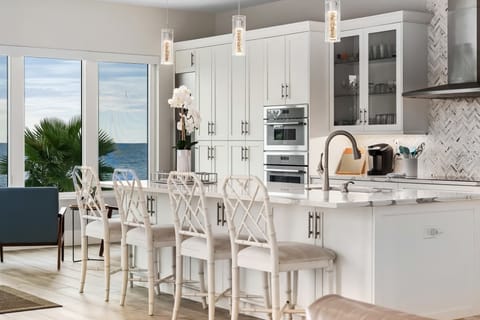 Cook and connect in a chef’s kitchen designed for gathering. With high-end appliances, an island breakfast bar, and ocean views, even meal prep feels like a vacation.