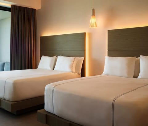 Stretch out together in a bright double-bed room setup.