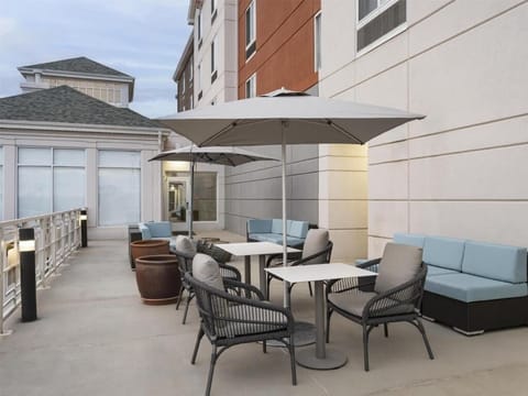 Unwind under the umbrella with breezy, open-air lounge seating.