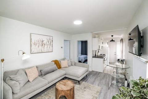 Spacious living area with sectional sofa, open layout, and access to kitchen