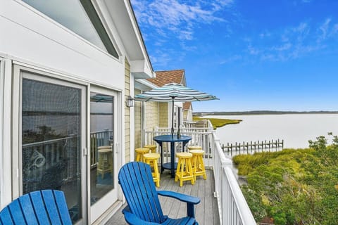 Outdoor dining off kitchen overlooking community pier and the bay.