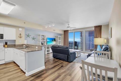 Spacious open-concept kitchen, dining, and living room with Gulf views.