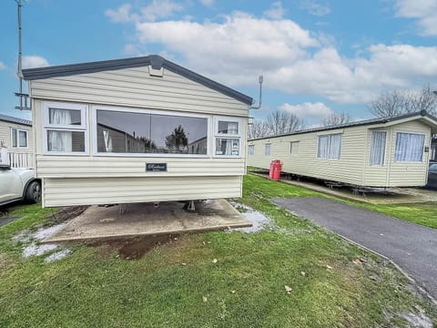 Cozy mobile home with bright sunroom and peaceful views