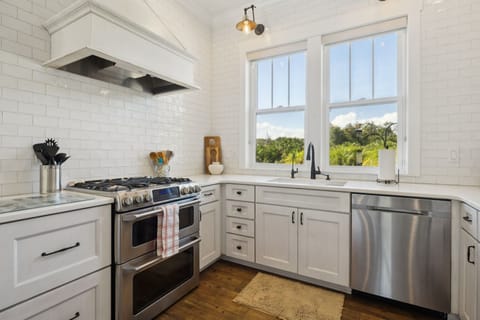 Full kitchen with stainless steel appliances including a gas 5-burner stove top and oven, refrigerator, drawer microwave, dishwasher, reverse osmosis water system, standard drip coffee maker, Nespresso machine, toaster, blender, crock pot, and fully stocked with all kitchen essentials.