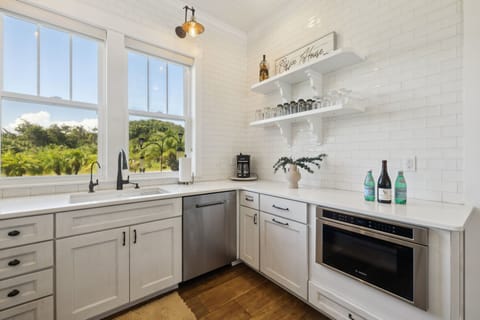 Full kitchen with stainless steel appliances including a gas 5-burner stove top and oven, refrigerator, drawer microwave, dishwasher, reverse osmosis water system, standard drip coffee maker, Nespresso machine, toaster, blender, crock pot, and fully stocked with all kitchen essentials.