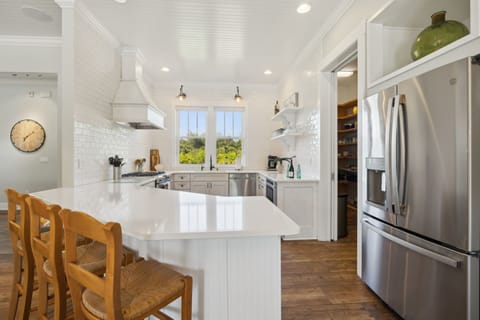 Full kitchen with stainless steel appliances including a gas 5-burner stove top and oven, refrigerator, drawer microwave, dishwasher, reverse osmosis water system, standard drip coffee maker, Nespresso machine, toaster, blender, crock pot, and fully stocked with all kitchen essentials.