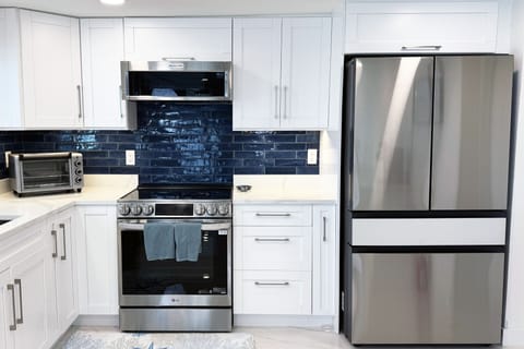 Stainless steel appliances including Refrigerator.