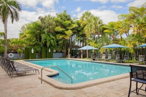 Bask in tropical sunshine beside a sparkling, tranquil pool.