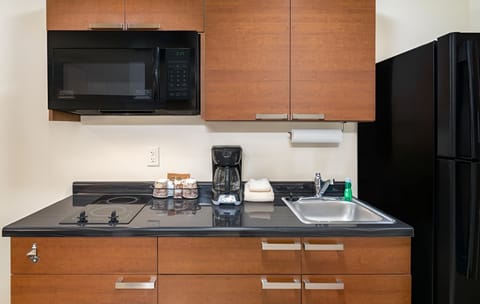 Cook and sip coffee with a sleek, fully equipped kitchenette.
