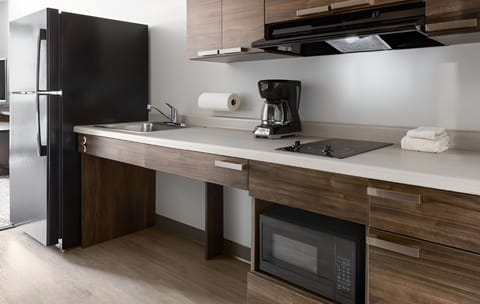 Prepare quick meals with sleek counters, microwave, and cooktop.