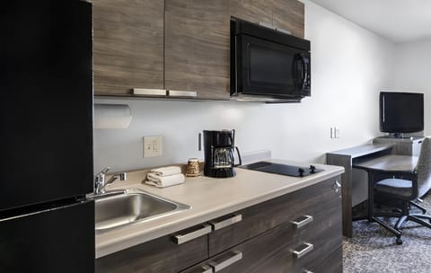 Cook and sip coffee easily with a stocked, modern kitchenette.