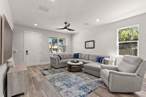 The living room's wrap-around couch makes this the perfect lounge space for large parties. 