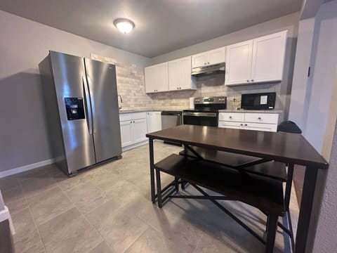 Fully equipped kitchen with cookware, dishes, and silverware, Coffee maker, microwave, stove, and refrigerator for easy meals