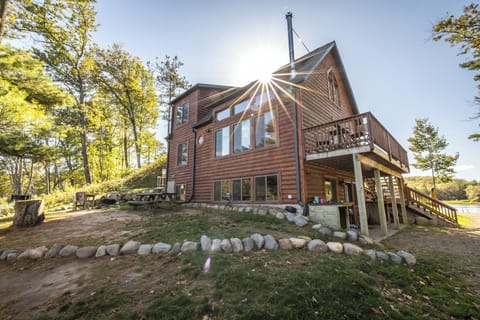 A view of the side of the cabin and driveway to launch and other lakeshore. 