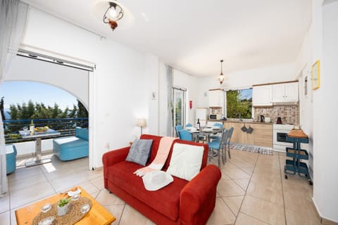 Open-plan living room with sofas, dining area, kitchen, A/C, WiFi internet, satellite TV, and sea views