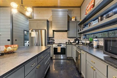 Fully stocked kitchen with stainless appliances and ample counter space