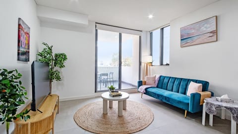Open-plan lounge with natural light and balcony access.