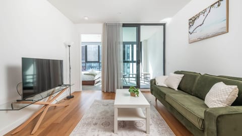 Contemporary living room with balcony access and timber floors