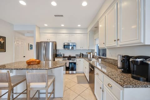 Kitchen with island and two barstools.