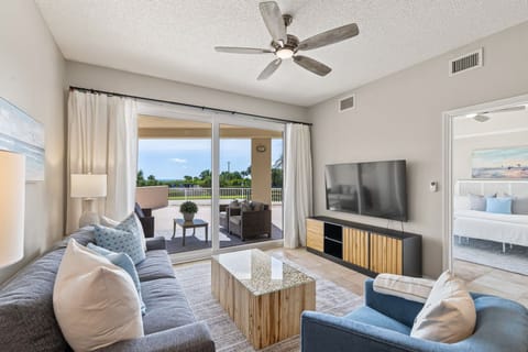 Seamless indoor-outdoor living is yours to enjoy, with stunning coastal views accessible from both the cozy living area and the expansive patio.