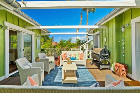 Open-air lanai with comfy seating & BBQ—sunny, private, and steps from both bedrooms.