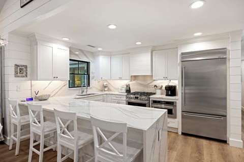 Fully equipped kitchen with bar stools for extra seating