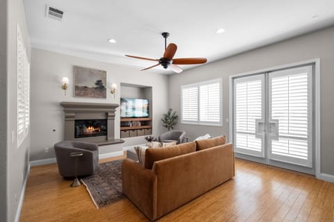 Cozy with sofa, fireplace, and sleek TV—perfect for relaxing or entertaining.