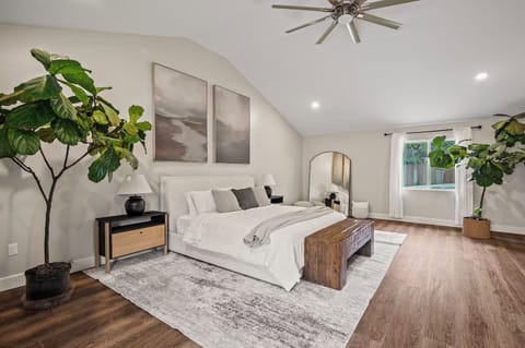 Relax in the spacious master suite with vaulted ceilings and green vibes.