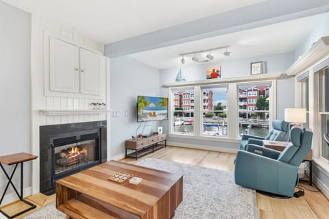 Open Living with Soundside Views — Relax in the bright, coastal-inspired living room where large windows frame stunning water views.