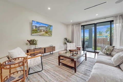 Bright, stylish living room with Smart TV and private patio access.