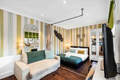 Bright living space with double bed and soft linens, sunlight streaming in