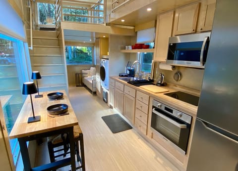 The well appointed kitchen with stainless appliances has a spacious counter top.