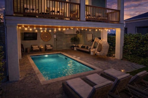 Inviting backyard with a sparkling pool and lounge chairs for relaxing in the sun.