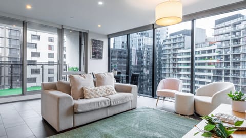 Bright and spacious living room with large windows and city views