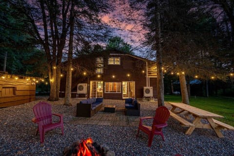 Back area with picnic table, firepit, and outdoor couch
