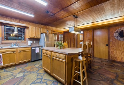 Spacious kitchen with island and bar seating.