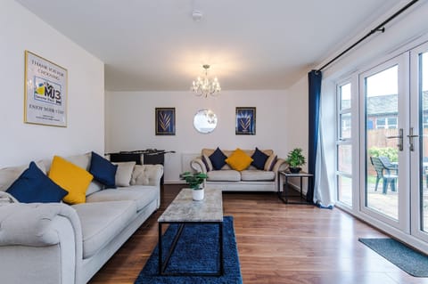 The spacious, bright and vibrant lounge benefits from a comfortable atmosphere and decor leading to the large rear garden via the French doors