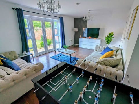 Relax or stay entertained with the 50" smart TV or foosball table