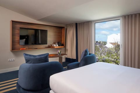 Unwind by the window with lounge seating and smart TV.
