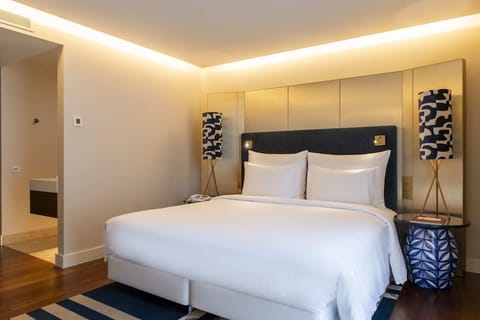Relax under soft ambient lighting in a serene, modern room.