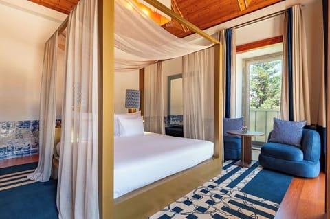 Relax in a romantic canopy bed with cozy seating nook.
