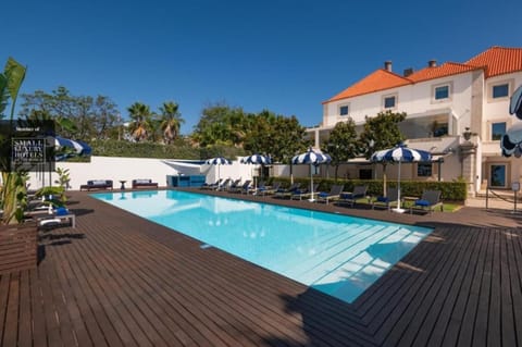 Savor sunny resort vibes with loungers beside the shimmering pool.