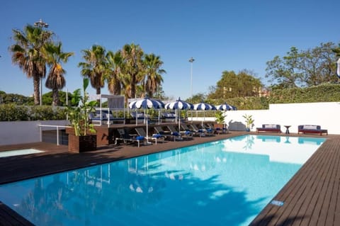 Swim long laps in a bright, tranquil pool setting.