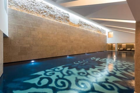 Drift into quiet relaxation beneath soft lights and calm water.