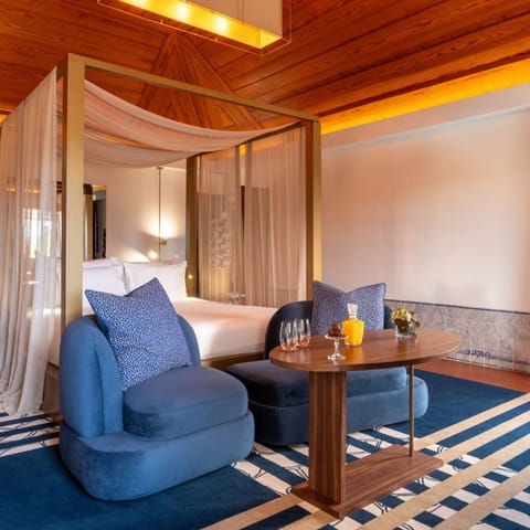 Unwind beneath the canopy bed in warm, wood-lined comfort.